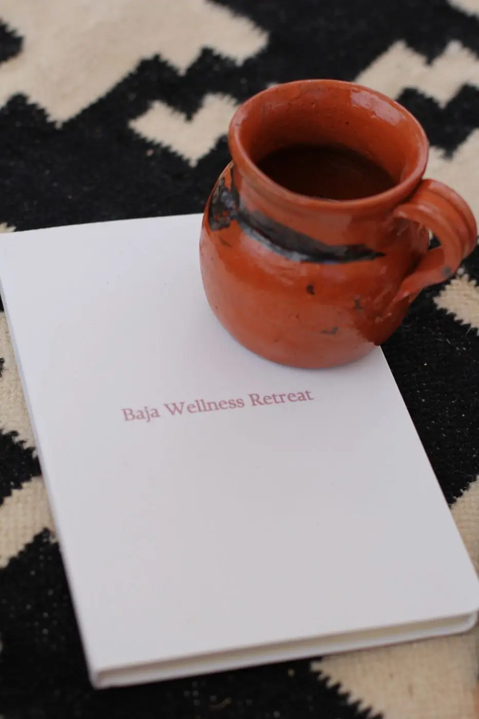 Cacao in a clay cup on a Baja Wellness Retreat journal