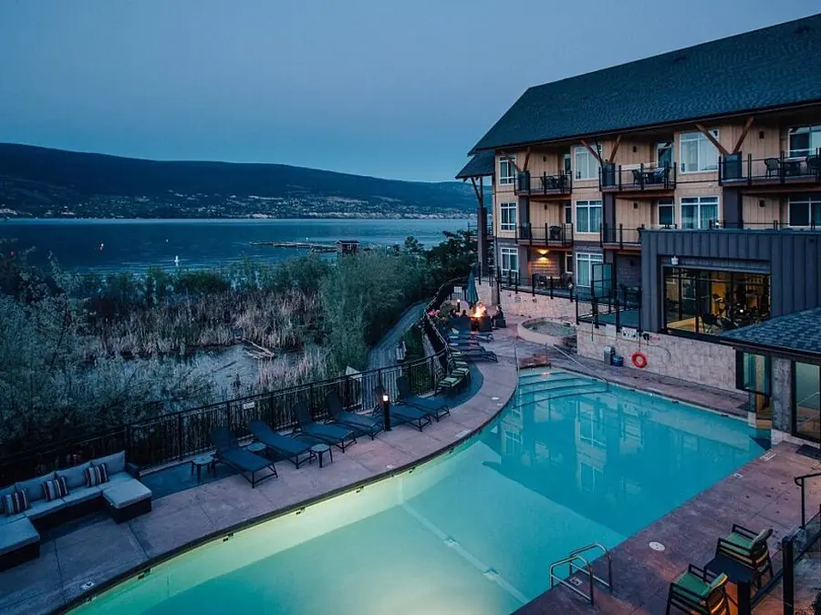 The pool and fire pit at dusk above the lake